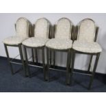 A set of four brass upholstered bar stools