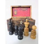 A 19th century mahogany box containing a turned ebony and boxwood chess set