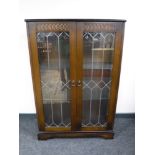 An oak leaded double door display cabinet