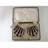 A pair of cased glass oyster dishes with silver forks