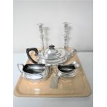 Two Georgian style silver plated candlesticks and a silver plated three-piece tea set