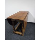 An oak gate leg table fitted a drawer