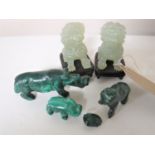 A pair of jade foo dogs on wooden stands, height 6cm,