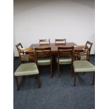 A reproduction mahogany dining table and six chairs (4 + 2)