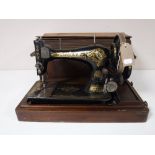 A mid twentieth century mahogany cased Singer hand sewing machine