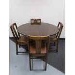 An oak extending dining table and four chairs