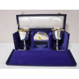 A pair of silver goblets and matching silver coasters, cased.