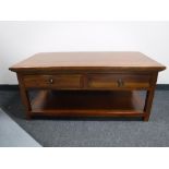A hardwood two tier coffee table fitted two drawers