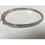 A 14ct gold diamond set bangle, 11.8g.