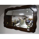 An Edwardian oak framed bevel edged mirror