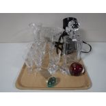 A tray containing glass paperweights, etched glass whiskey decanter,