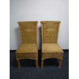A pair of wicker high back dining chairs