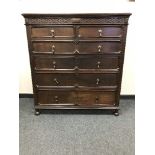 An Edwardian oak six drawer,