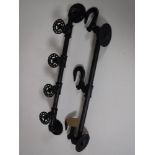 Two cast iron coat racks