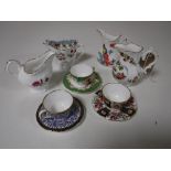 Four Royal Worcester milk jugs and three Royal Worcester miniature cups and saucers
