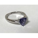 A platinum triangular cut tanzanite ring, size K.