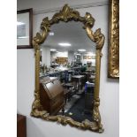 An ornate gilt wood hall mirror