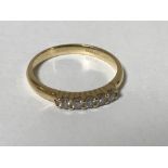 An 18ct gold five stone diamond ring, approximately 0.25ct, size N, 3g.