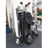 A golf bags containing various irons and drivers and a bundle of irons