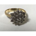 An 18ct gold diamond cluster ring set with 19 brilliant cut stones,