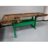 A mid 20th century wooden work bench CONDITION REPORT: This measures 235cm long,