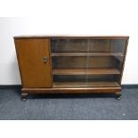 A mid twentieth century mahogany sliding glass door bookcase,