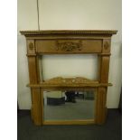 A carved oak fire surround with over mantel mirror