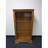 A teak glazed door display cabinet