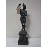 A spelter figure on slate stand