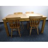 A rectangular pine kitchen table together with four chairs