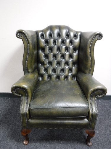 A green button leather Chesterfield chair