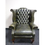 A green button leather Chesterfield chair