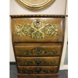 A bureau with decorative metal stud work and scroll design,