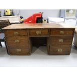 A antique pine seven drawer knee hole desk