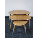 A nest of three Ercol elm pebble tables