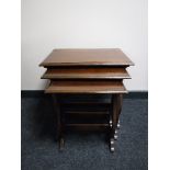 A nest of three mahogany tables