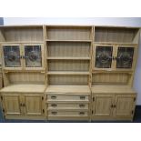 A 20th century blonde oak triple section bookcase fitted cupboards beneath