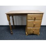 A pine dressing table fitted three drawers