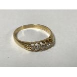 An 18ct gold five stone diamond ring, size O, 2.7g.