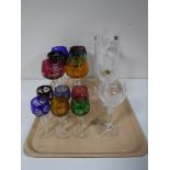 A tray containing a set of six German coloured cut glass wine glasses with matching liqueur glasses,