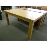 A contemporary oak dining table