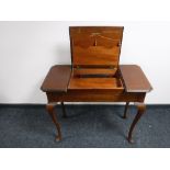 An antique mahogany correspondence table