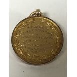A 9ct gold disc fob presented to Lieut J D Milburn for valour in the Great War, 8.5g.