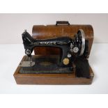 An oak cased mid twentieth century Singer hand sewing machine