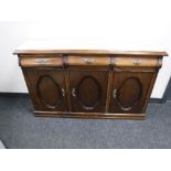 A narrow triple door and marble topped sideboard