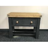 A reclaimed pine butchers block fitted a drawer on a painted base