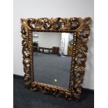 A contemporary gilt framed Rococo style mirror