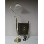 A brass floor lamp with shade,