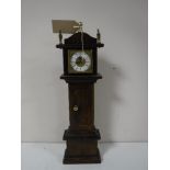 An oak cased miniature grandfather clock