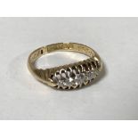 An 18ct gold five stone diamond ring, size J, 2.6g.